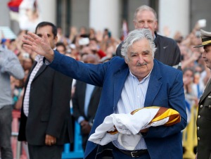 Uruguay's President Jose Mujica waves to the people after receiving the Uruguayan flag on the last working day of his term in Montevideo